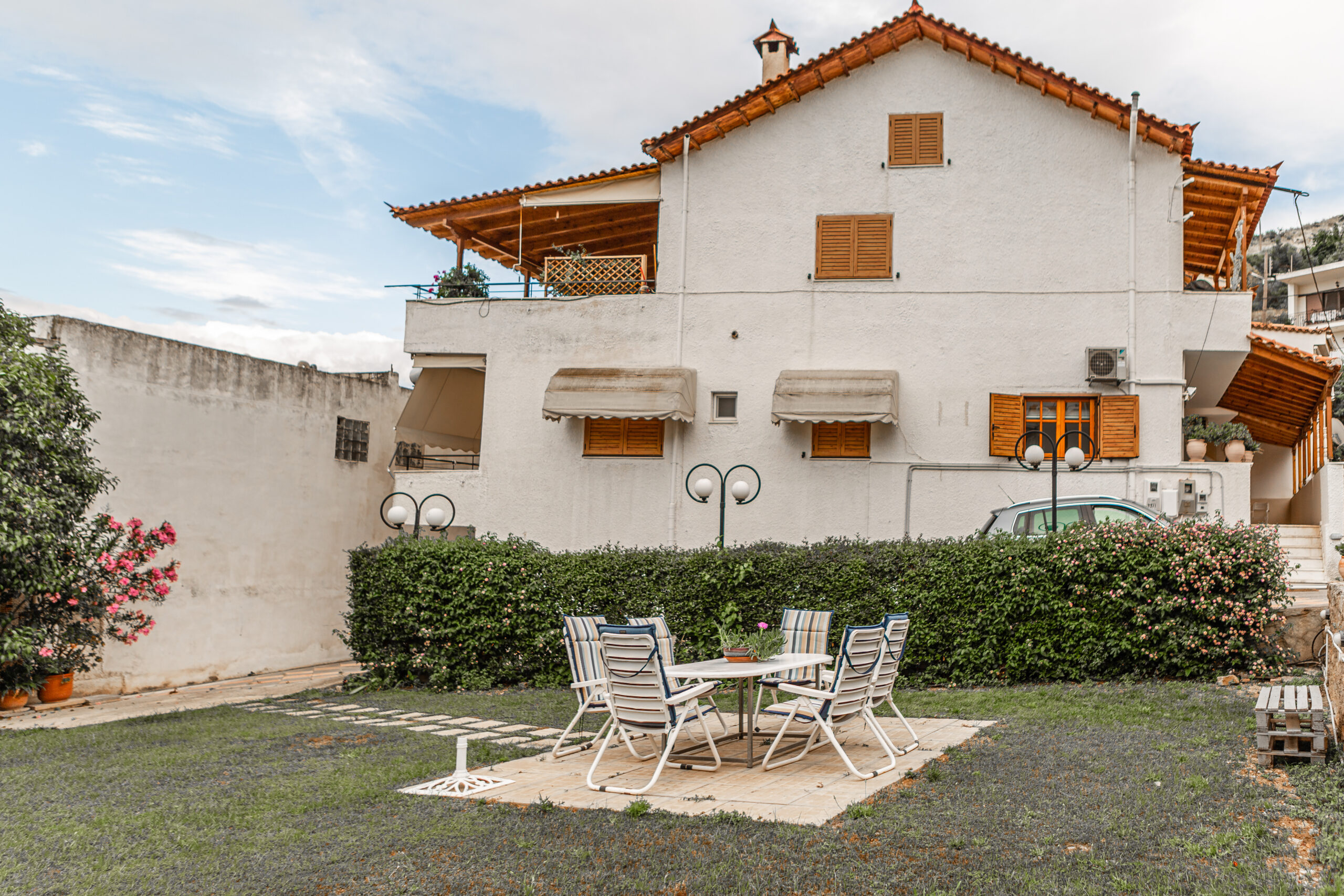 Garden area that appears a table with 6 seats and our building that apartments are located