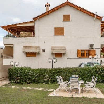 Garden area that appears a table with 6 seats and our building that apartments are located